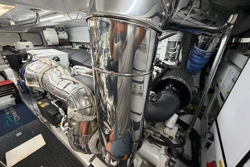 Slide: The Image of Engine room of a 2020 Horizon E56 yacht, showcasing complex machinery and components. - 103