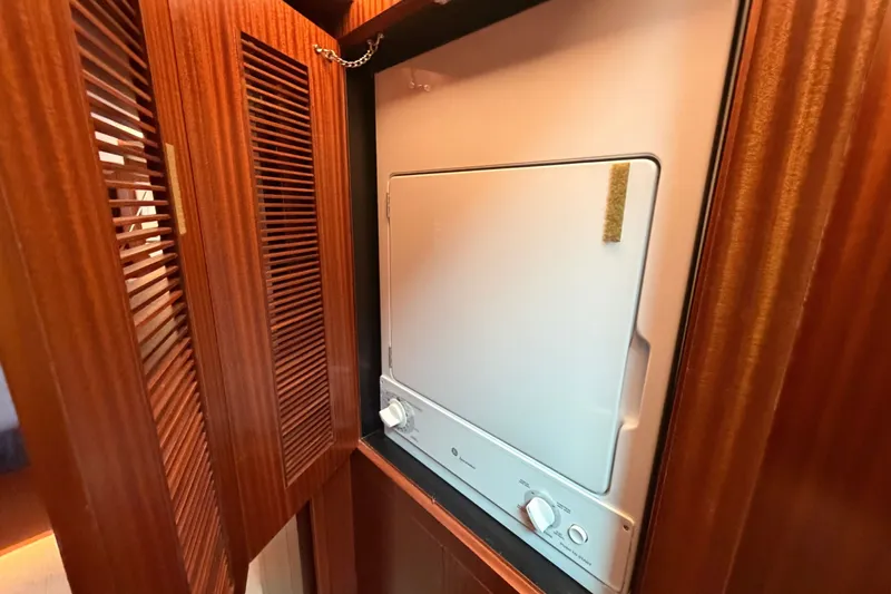 Slide: The Image of Compact laundry unit in wooden cabinet on Horizon E56, 2020 model yacht. - 64
