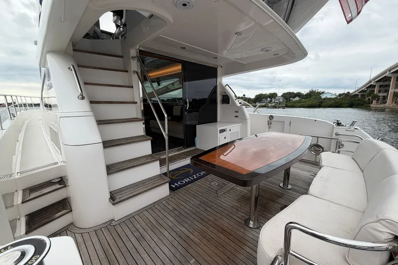 Slide: The Image of Luxurious 2020 Horizon E56 yacht deck with seating, table, and staircase. - 17