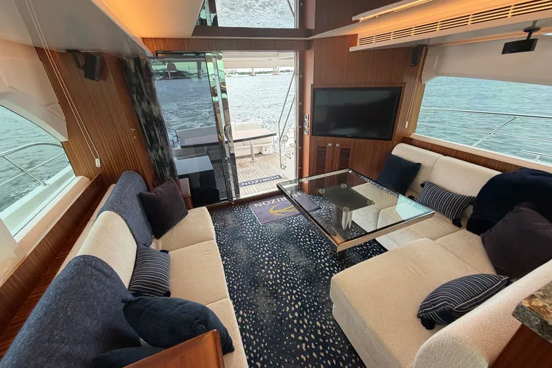Slide: The Image of Luxurious 2020 Horizon E56 yacht interior with elegant seating, glass table, and waterfront view. - 29
