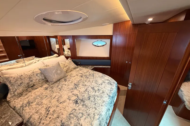 Slide: The Image of Luxurious bedroom interior of 2020 Horizon E56 yacht with elegant wood paneling and plush bedding. - 78
