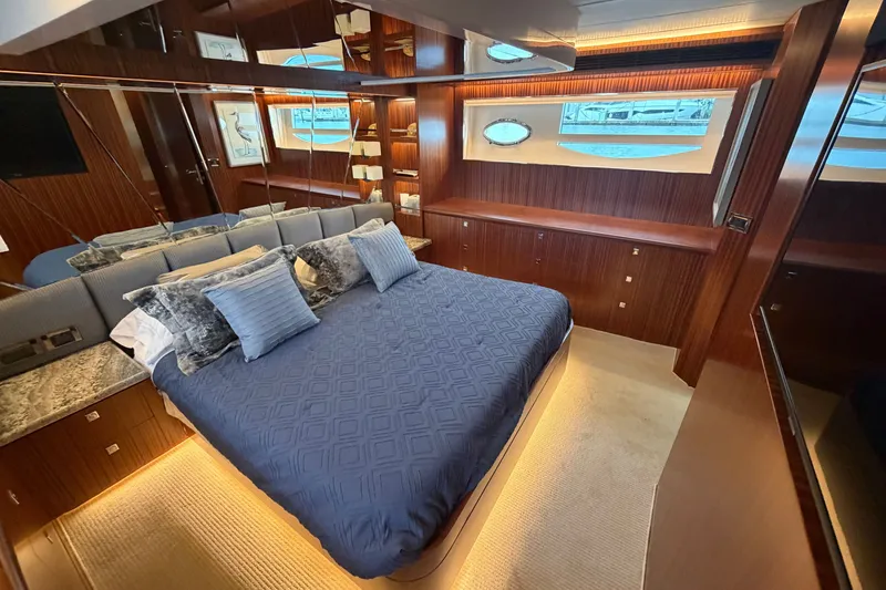 Slide: The Image of Luxurious bedroom interior of 2020 Horizon E56 yacht with elegant wood finishes and plush bedding. - 51