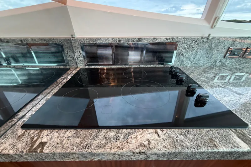Slide: The Image of Modern kitchen with sleek black cooktop on granite countertop in Horizon E56 yacht, 2020 model. - 43