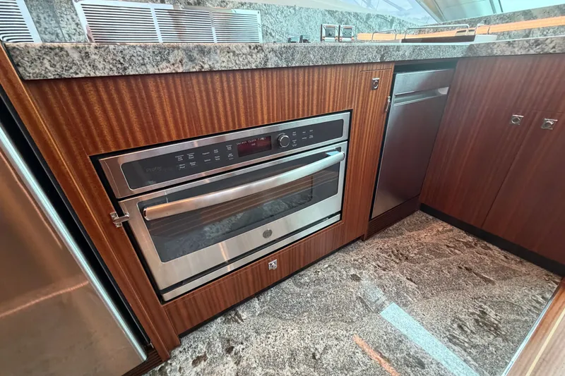 Slide: The Image of Modern kitchen with stainless steel oven, granite countertop, and wooden cabinetry on Horizon E56 yacht. - 42