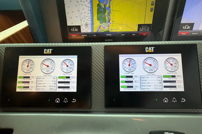 Slide: The Image of Boat dashboard with CAT engine monitors and navigation display, Horizon E56, 2020 model. - 35