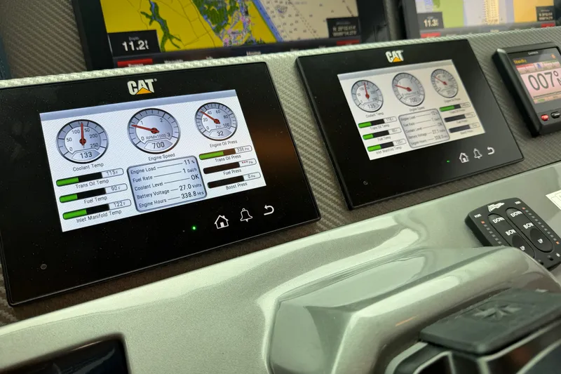 Slide: The Image of Control panel with CAT engine monitors on a 2020 Horizon E56 yacht. - 70