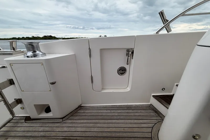Slide: The Image of Deck area of a 2020 Horizon E56 yacht with sleek design and wooden flooring. - 48