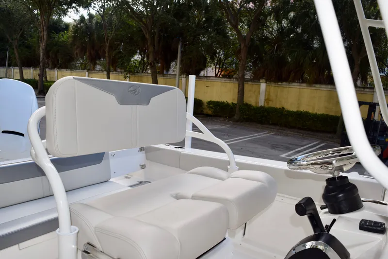Slide: The Image of 2026 Sailfish 232 CC boat interior with cushioned seating and steering wheel. - 8