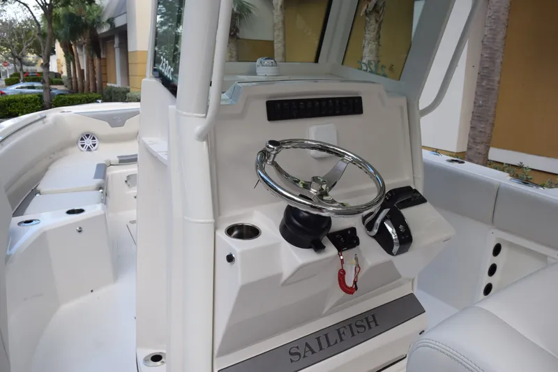 Slide: The Image of 2026 Sailfish 232 CC boat console with steering wheel and controls. - 12