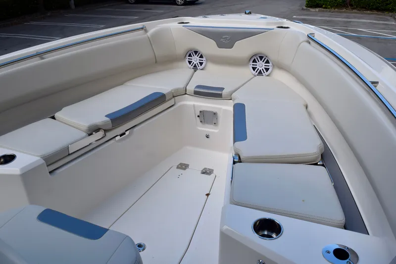 Slide: The Image of 2026 Sailfish 232 CC boat interior with cushioned seating and built-in speakers. - 4