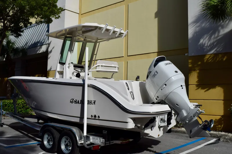 Slide: The Image of 2026 Sailfish 232 CC boat on trailer with Suzuki outboard motor. - 1