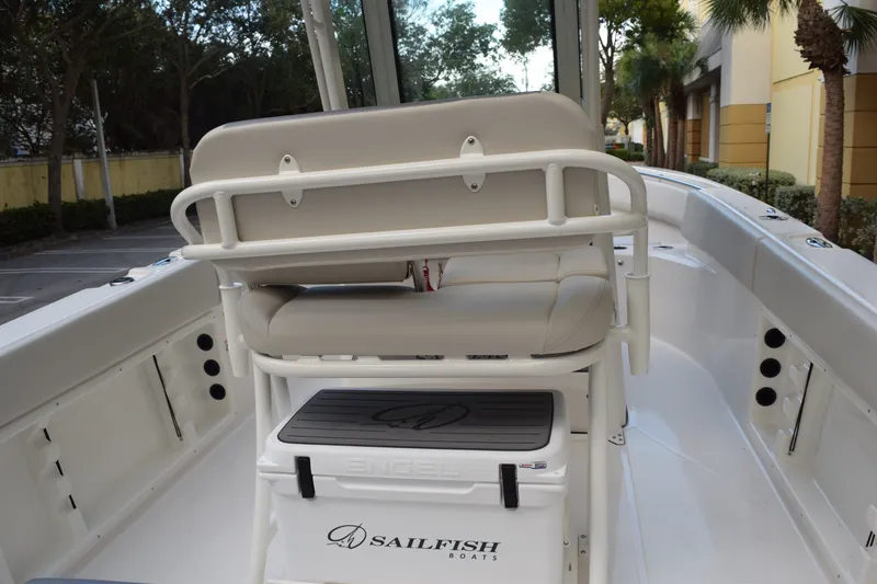 Slide: The Image of 2026 Sailfish 232 CC boat interior with seating and storage, featuring sleek white design. - 9