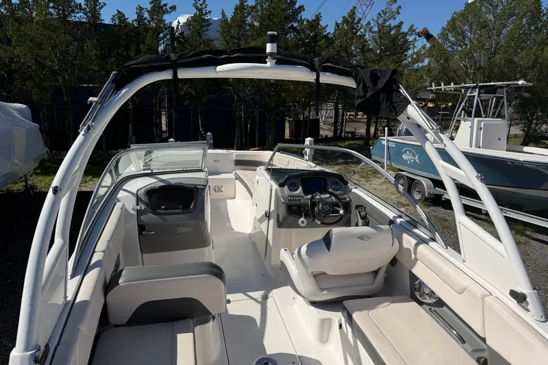 Slide: The Image of 2016 Chaparral 250 Suncoast boat interior with steering wheel and seating. - 25