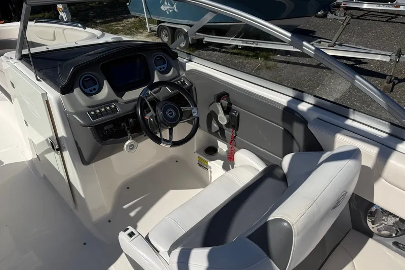 Slide: The Image of 2016 Chaparral 250 Suncoast boat interior with steering wheel and dashboard controls. - 15