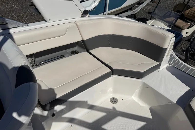 Slide: The Image of 2016 Chaparral 250 Suncoast boat interior with beige and gray seating. - 19
