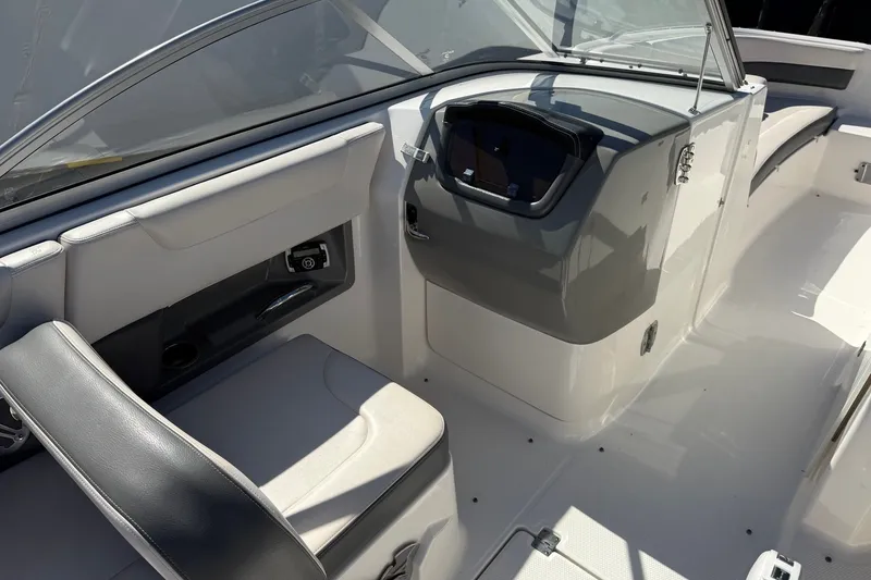 Slide: The Image of 2016 Chaparral 250 Suncoast boat interior with sleek seating and modern dashboard design. - 17