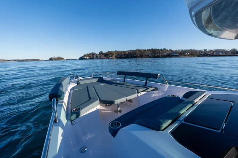 Slide: The Image of 2026 Axopar 29 XC Cross Cabin boat on calm waters with scenic shoreline view. - 11