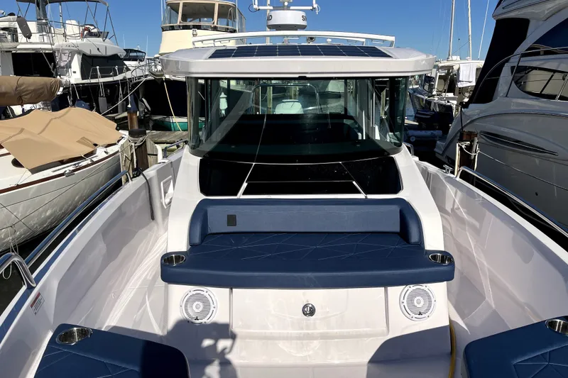 Slide: The Image of 2026 Axopar 29 XC Cross Cabin boat docked among other vessels. - 31