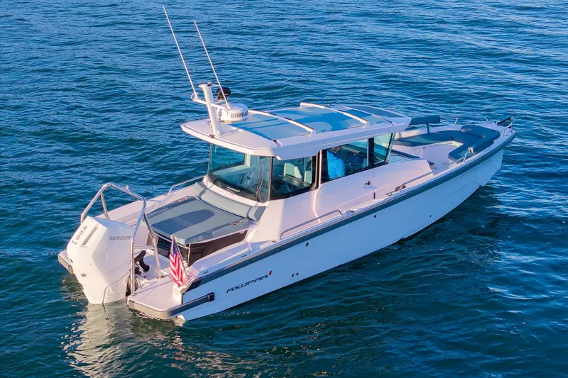 Slide: The Image of 2026 Axopar 29 XC Cross Cabin boat cruising on open water. - 3