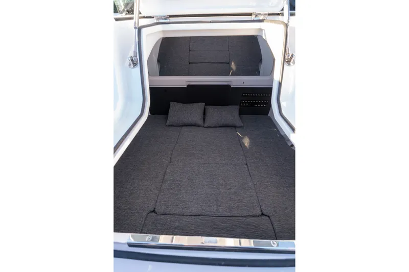 Slide: The Image of 2026 Axopar 29 XC Cross Cabin interior with gray cushioned sleeping area. - 32
