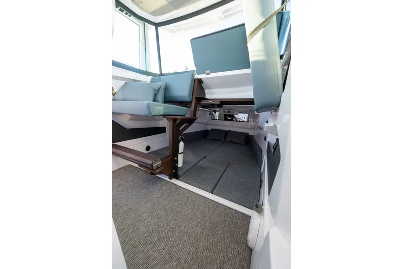 Slide: The Image of Interior of 2026 Axopar 29 XC Cross Cabin, featuring seating and sleeping area. - 31