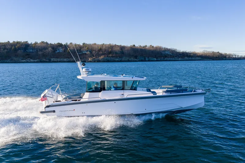 Slide: The Image of 2026 Axopar 29 XC Cross Cabin cruising on open water, showcasing sleek design and performance. - 6
