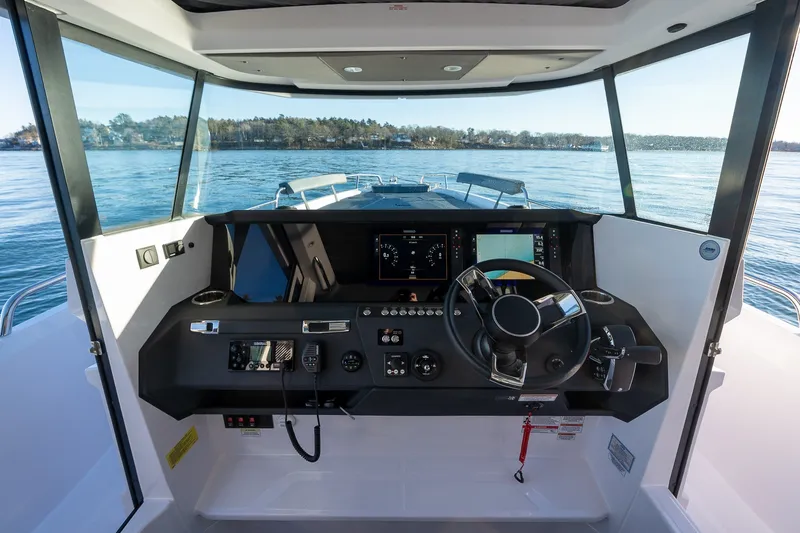 Slide: The Image of 2026 Axopar 29 XC Cross Cabin helm with modern controls and panoramic water view. - 15