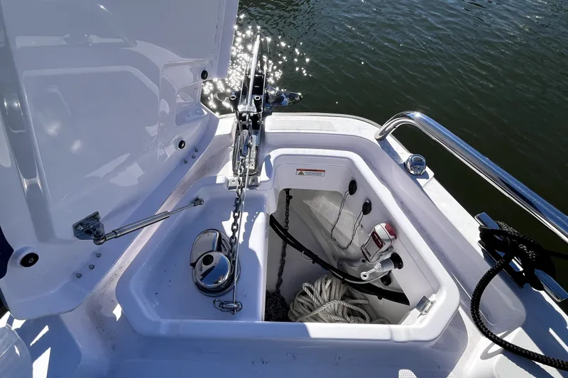 Slide: The Image of Anchor compartment of 2026 Axopar 29 XC Cross Cabin with chain and rope storage. - 32