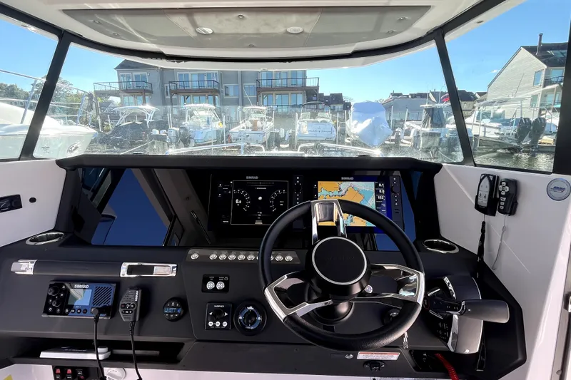 Slide: The Image of 2026 Axopar 29 XC Cross Cabin helm with modern navigation displays and controls. - 29