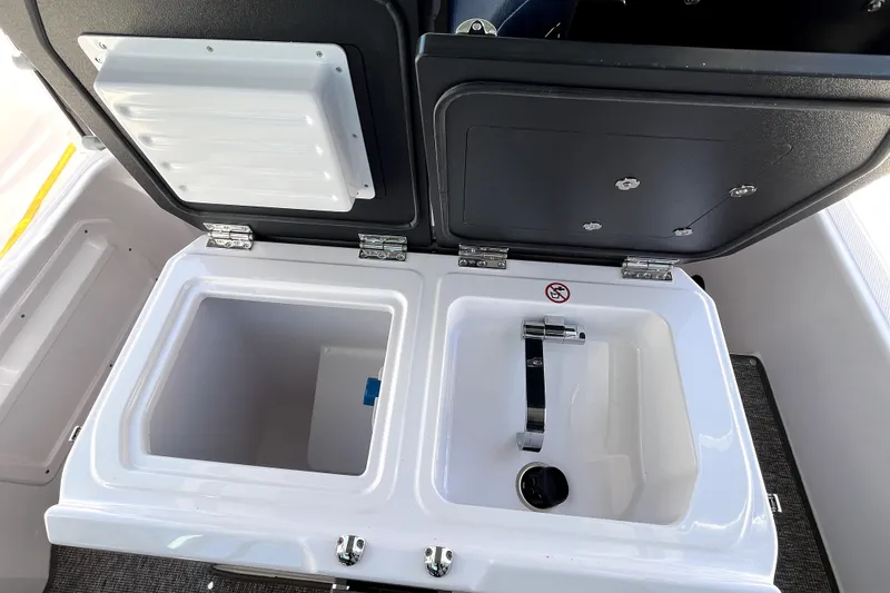 Slide: The Image of Open storage compartments on 2026 Axopar 29 XC Cross Cabin boat, showcasing interior features. - 26