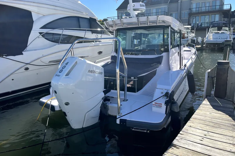 Slide: The Image of 2026 Axopar 29 XC Cross Cabin boat docked with Mercury 400 engine. - 3