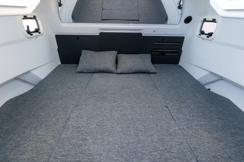 Slide: The Image of Interior cabin of 2026 Axopar 29 XC Cross Cabin with gray bedding and pillows. - 36