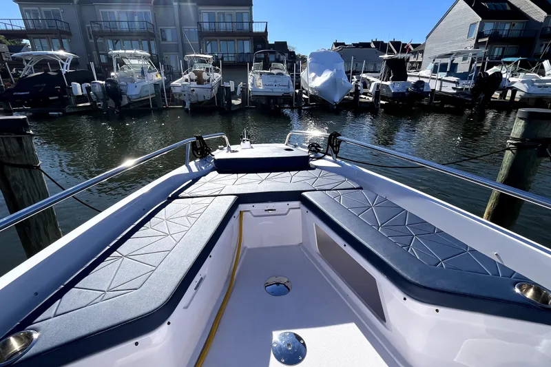 Slide: The Image of 2026 Axopar 29 XC Cross Cabin boat docked at marina with blue seating. - 34