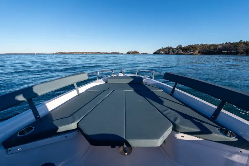 Slide: The Image of 2026 Axopar 29 XC Cross Cabin boat on calm blue water, scenic coastal view. - 8