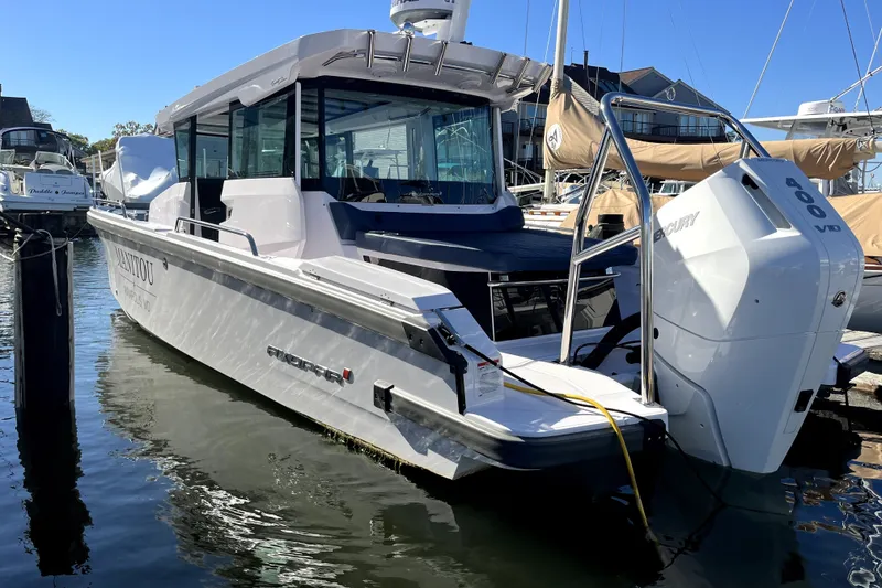 Slide: The Image of 2026 Axopar 29 XC Cross Cabin boat docked with Mercury 400 V10 engine. - 2