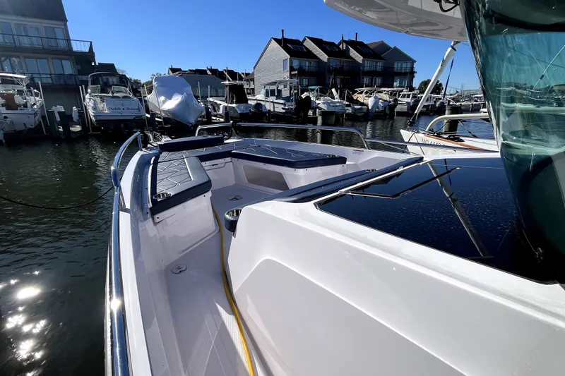 Slide: The Image of 2026 Axopar 29 XC Cross Cabin docked at marina under clear blue sky. - 36
