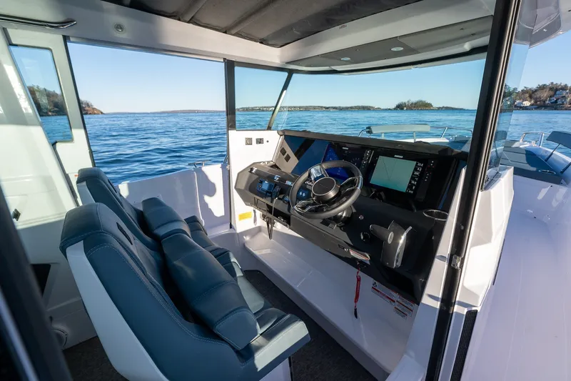 Slide: The Image of Interior of 2026 Axopar 29 XC Cross Cabin, featuring modern helm and dual seating. - 16