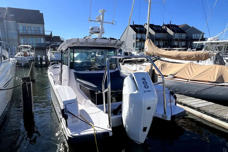 Slide: The Image of 2026 Axopar 29 XC Cross Cabin boat docked with powerful 400 V10 engine. - 9