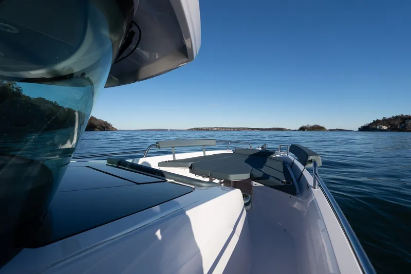 Slide: The Image of 2026 Axopar 29 XC Cross Cabin cruising on calm waters under clear blue skies. - 12