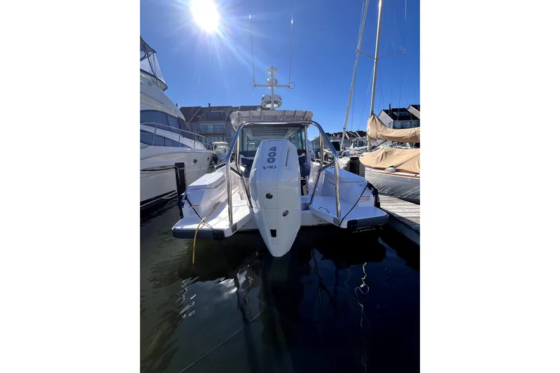 Slide: The Image of 2026 Axopar 29 XC Cross Cabin boat docked under bright sunlight. - 10