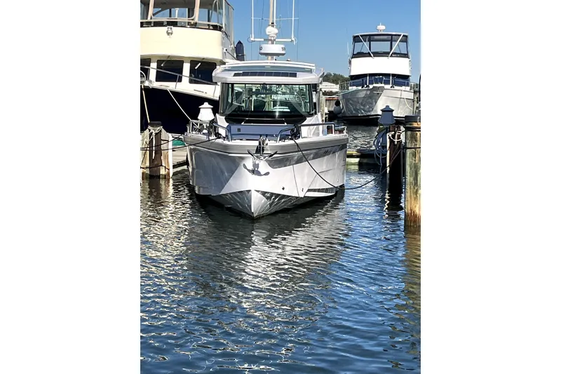 Slide: The Image of 2026 Axopar 29 XC Cross Cabin boat docked in marina, front view. - 7