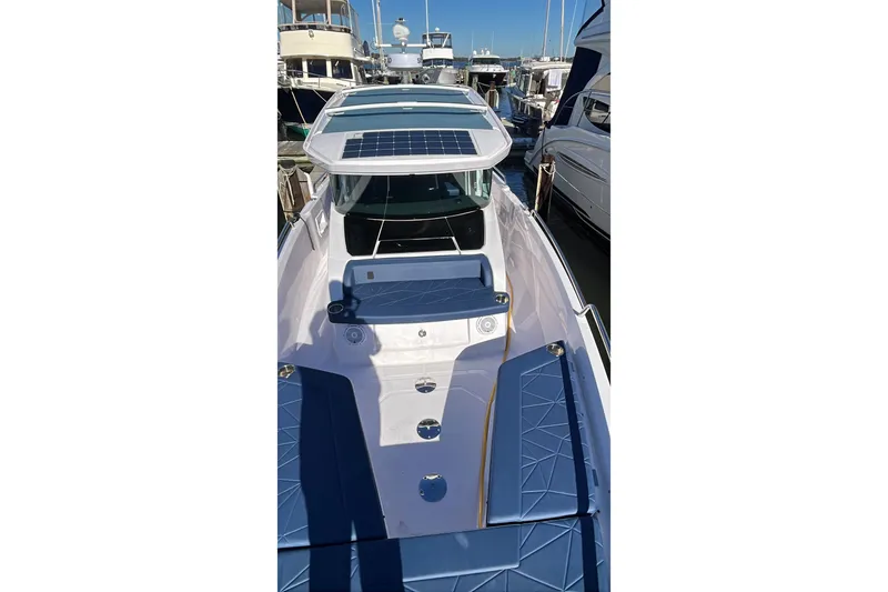 Slide: The Image of 2026 Axopar 29 XC Cross Cabin boat docked, featuring sleek design and solar panels. - 41