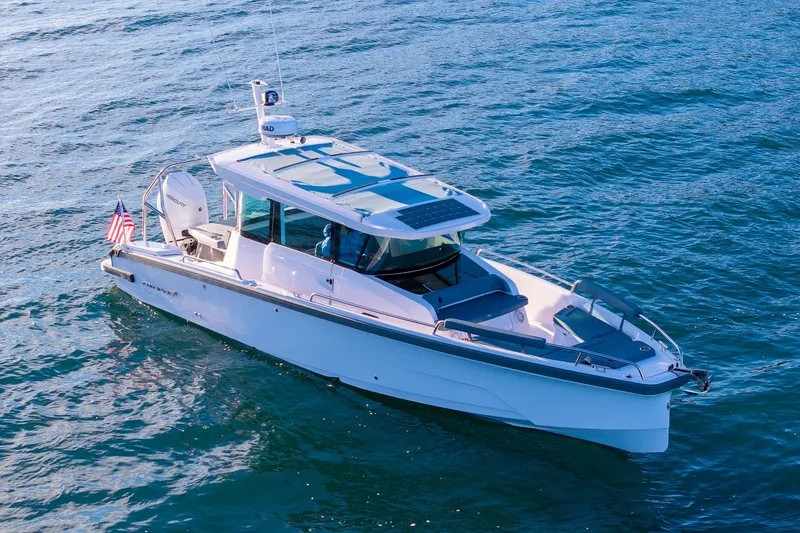 Slide: The Image of 2026 Axopar 29 XC Cross Cabin boat cruising on open water. - 2
