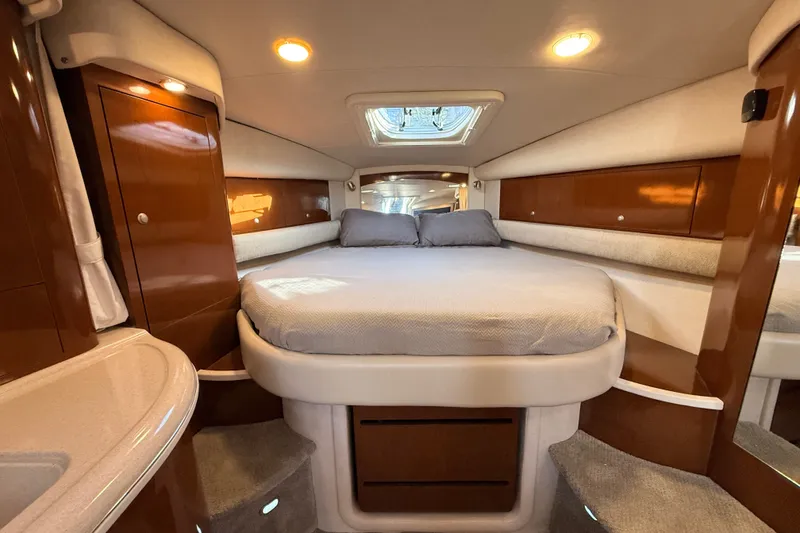 Slide: The Image of Luxurious cabin interior of 2008 Sea Ray 340 Sundancer with cozy bed and elegant wood finishes. - 29