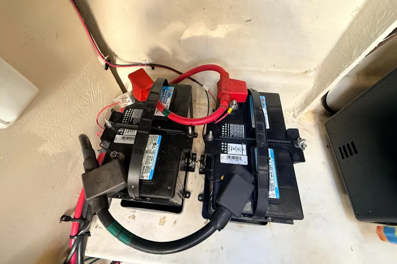 Slide: The Image of Batteries in a 2008 Sea Ray 340 Sundancer boat, connected with red and black cables. - 43