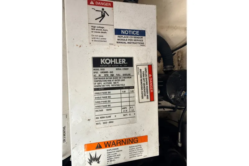 Slide: The Image of Kohler generator panel with safety warnings on a 2008 Sea Ray 340 Sundancer boat. - 42