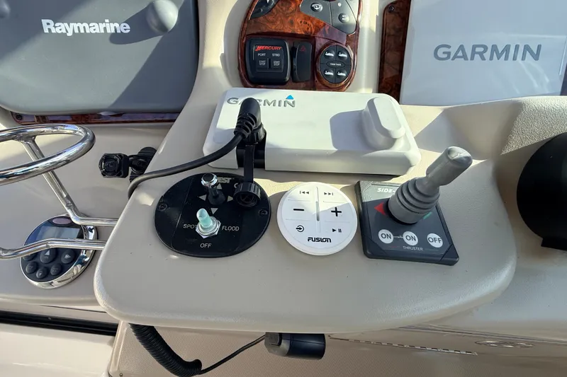 Slide: The Image of Control panel of a 2008 Sea Ray 340 Sundancer with Garmin and Raymarine equipment. - 18