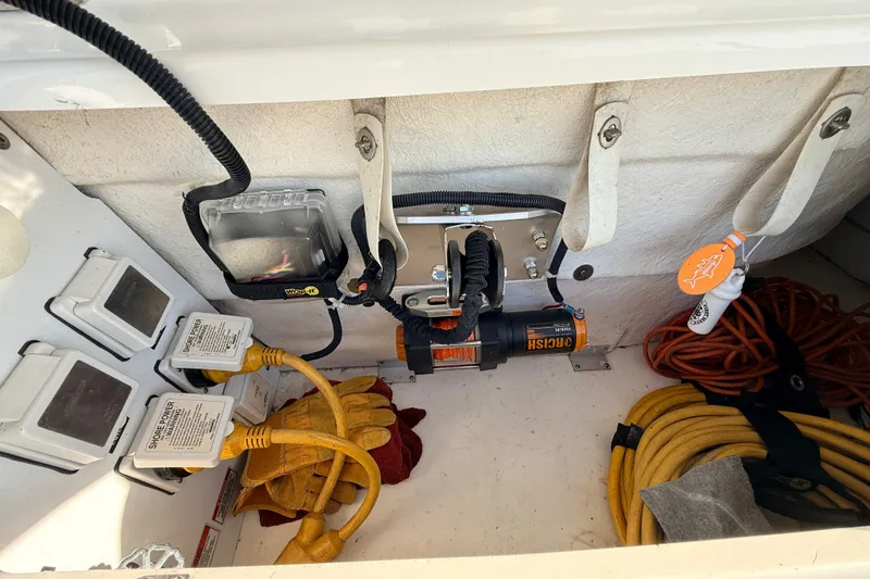 Slide: The Image of Storage compartment of a 2008 Sea Ray 340 Sundancer with electrical cables and tools. - 48