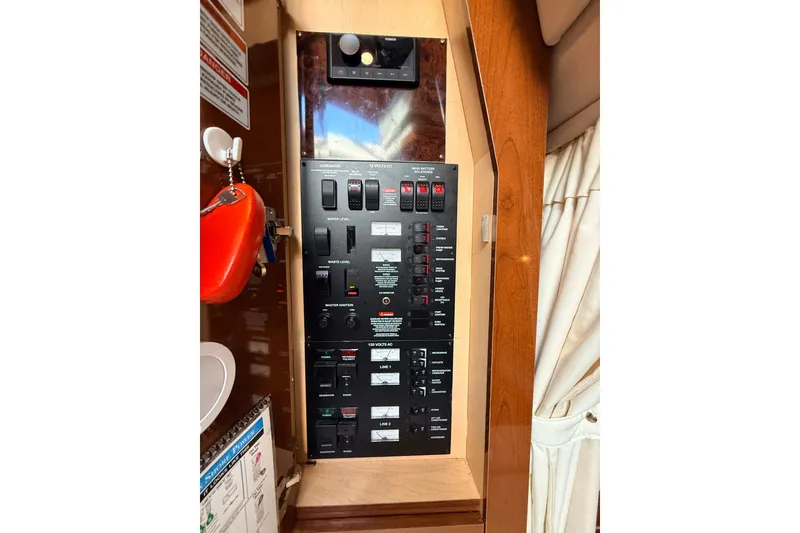 Slide: The Image of Electrical control panel on a 2008 Sea Ray 340 Sundancer boat interior. - 47