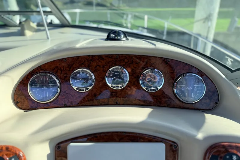 Slide: The Image of Dashboard of a 2008 Sea Ray 340 Sundancer boat with wood paneling and gauges. - 17